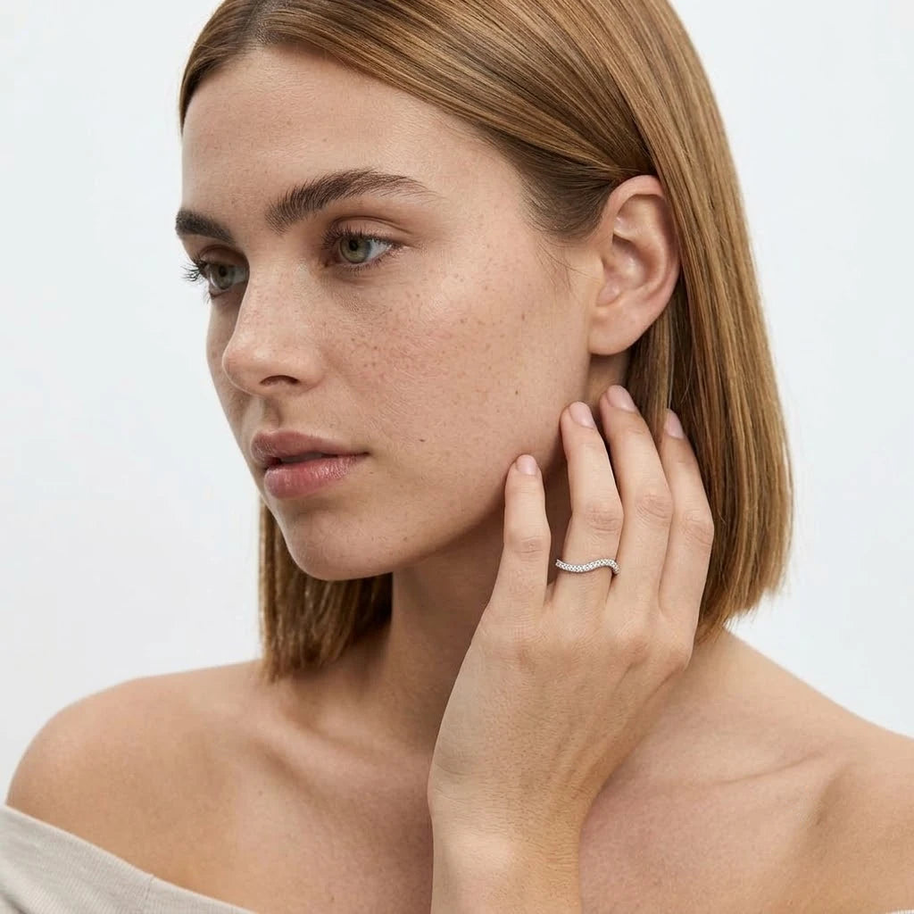 FineDiam slim diamond wedding band featuring a gentle curved profile and sparkling round stones in white metal.