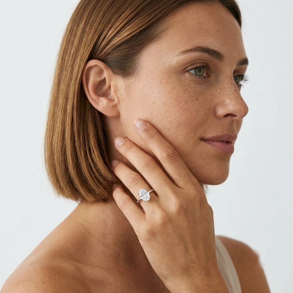 FineDiam double oval diamond cluster ring featuring two sparkling oval-shaped clusters on a slim white metal band.