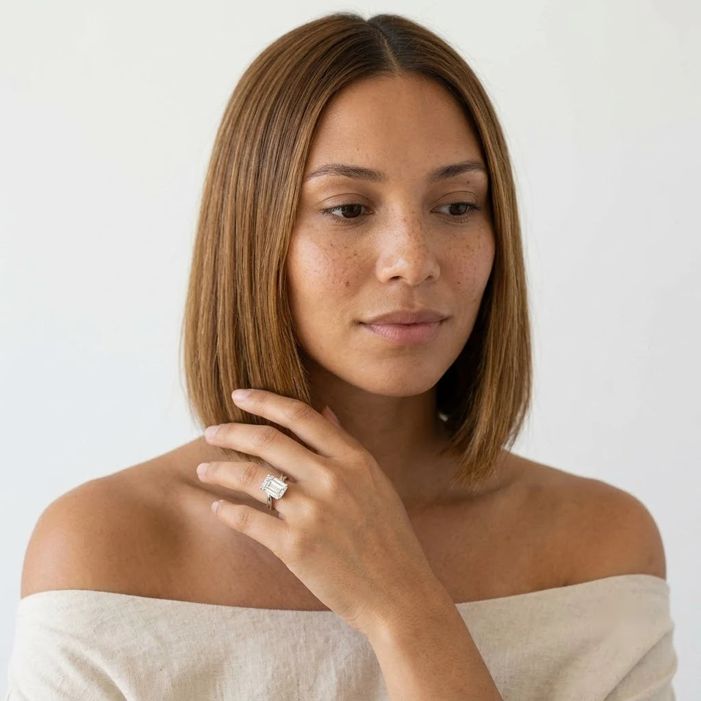  FineDiam emerald cut diamond solitaire ring featuring a rectangular step cut centre stone and polished white metal band.