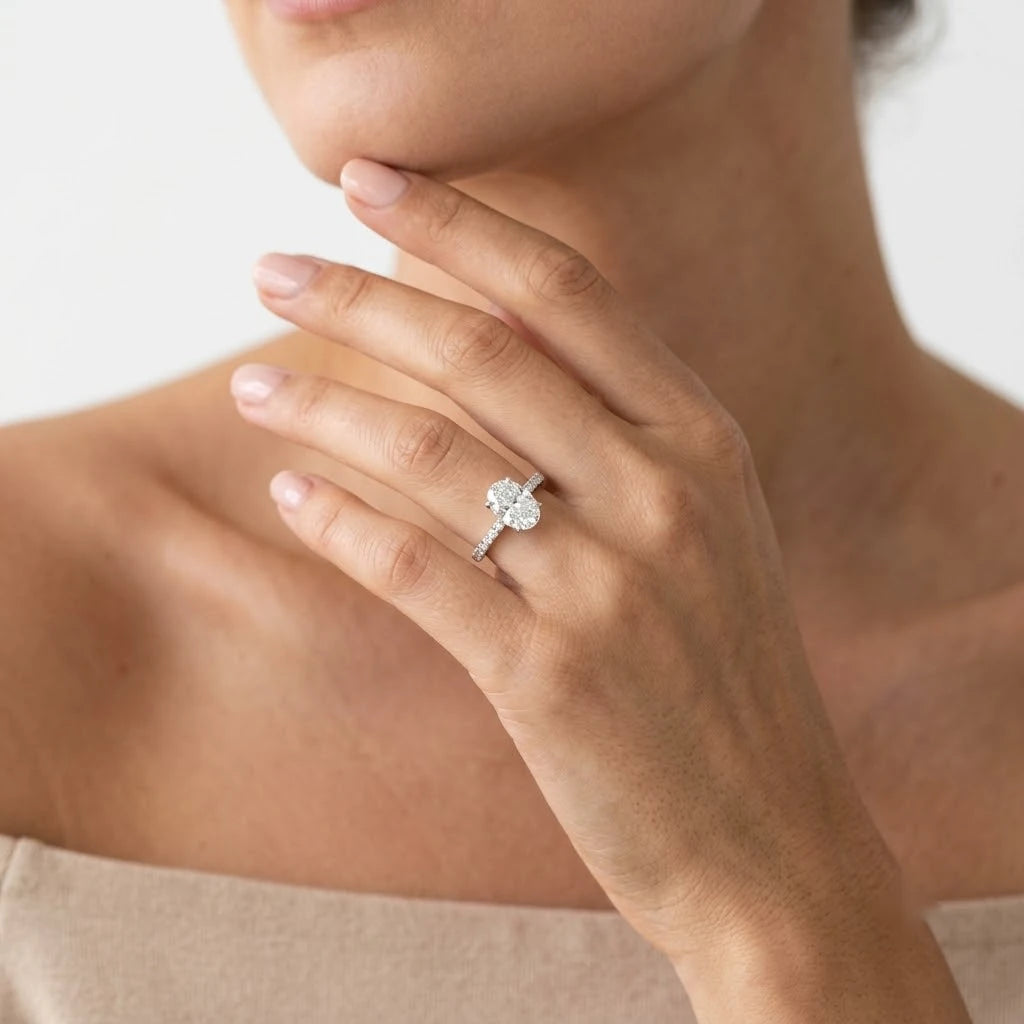 FineDiam oval diamond halo engagement ring featuring a diamond surrounded centre and pave set band.