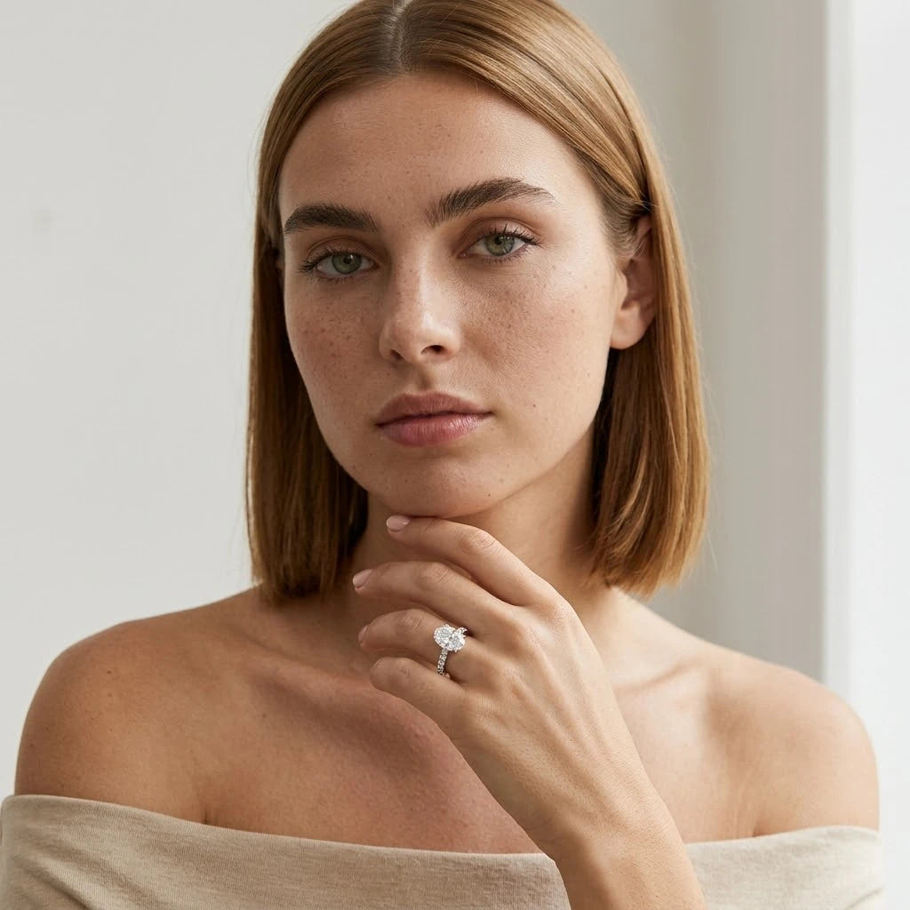 FineDiam oval diamond cluster ring featuring a sparkling halo design and slim white metal band.