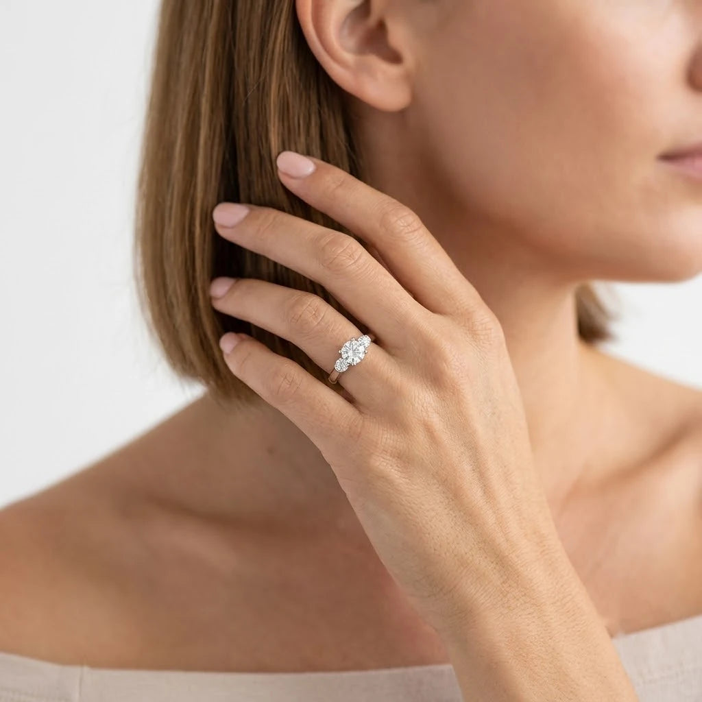  FineDiam pear diamond cluster ring featuring a sparkling pear-shaped centre and diamond-accented shoulders.