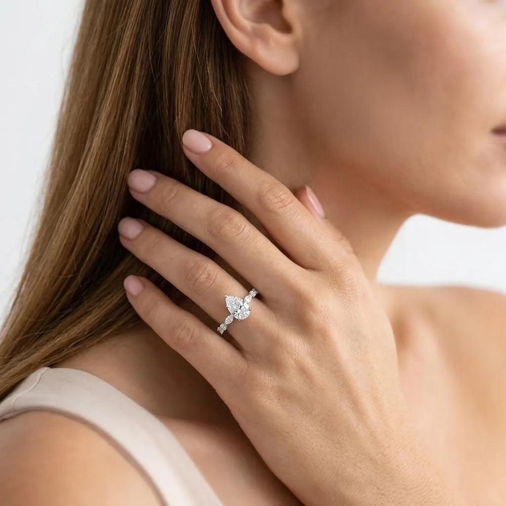 FineDiam pear and round diamond ring featuring an asymmetrical design with diamond set shoulders.