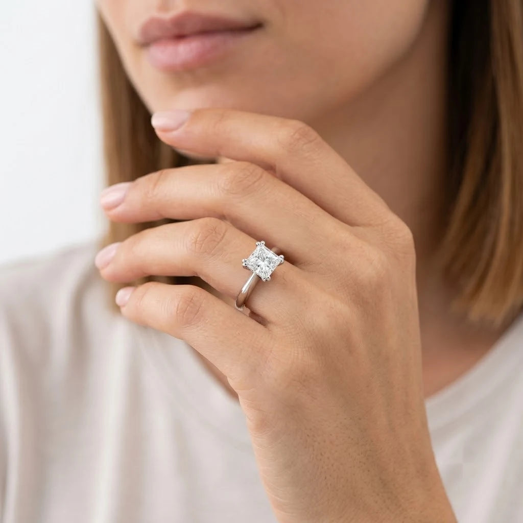 FineDiam princess cut solitaire diamond ring featuring a square brilliant centre stone secured by four prongs.