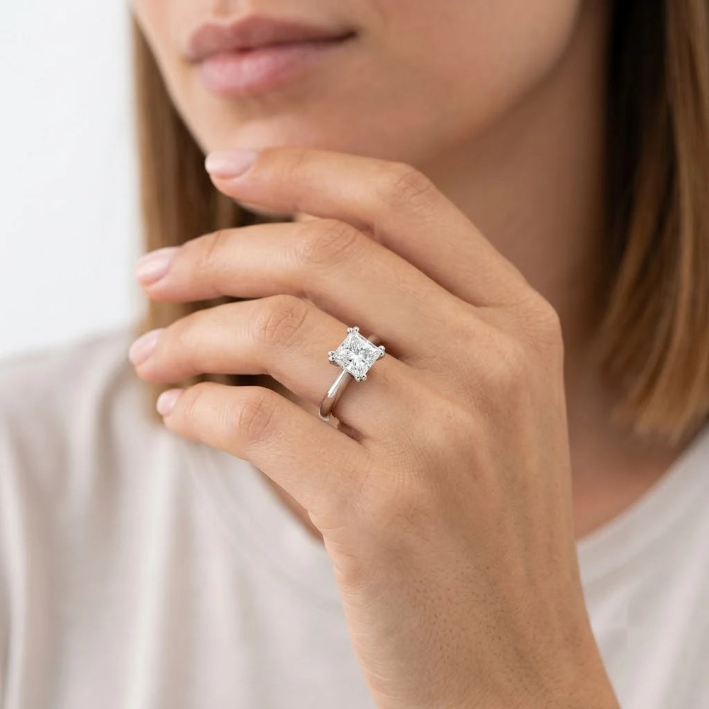 FineDiam princess cut solitaire diamond ring featuring a square brilliant centre stone secured by four prongs.