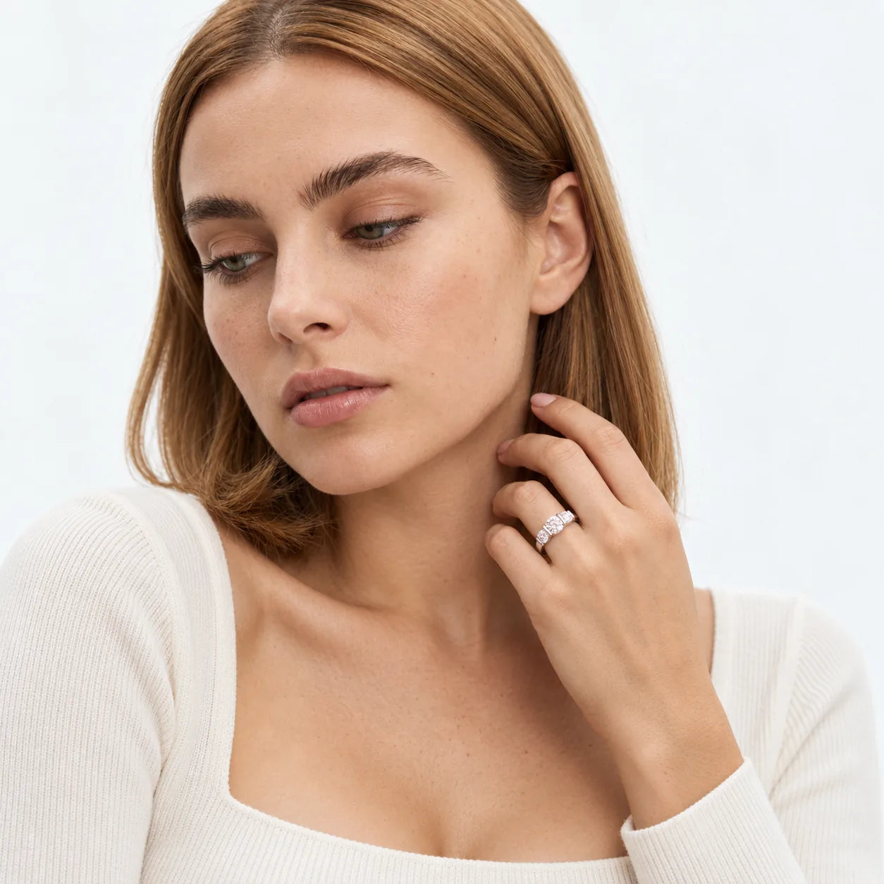 FineDiam diamond cluster ring featuring three square-shaped stone settings along a polished white metal band.