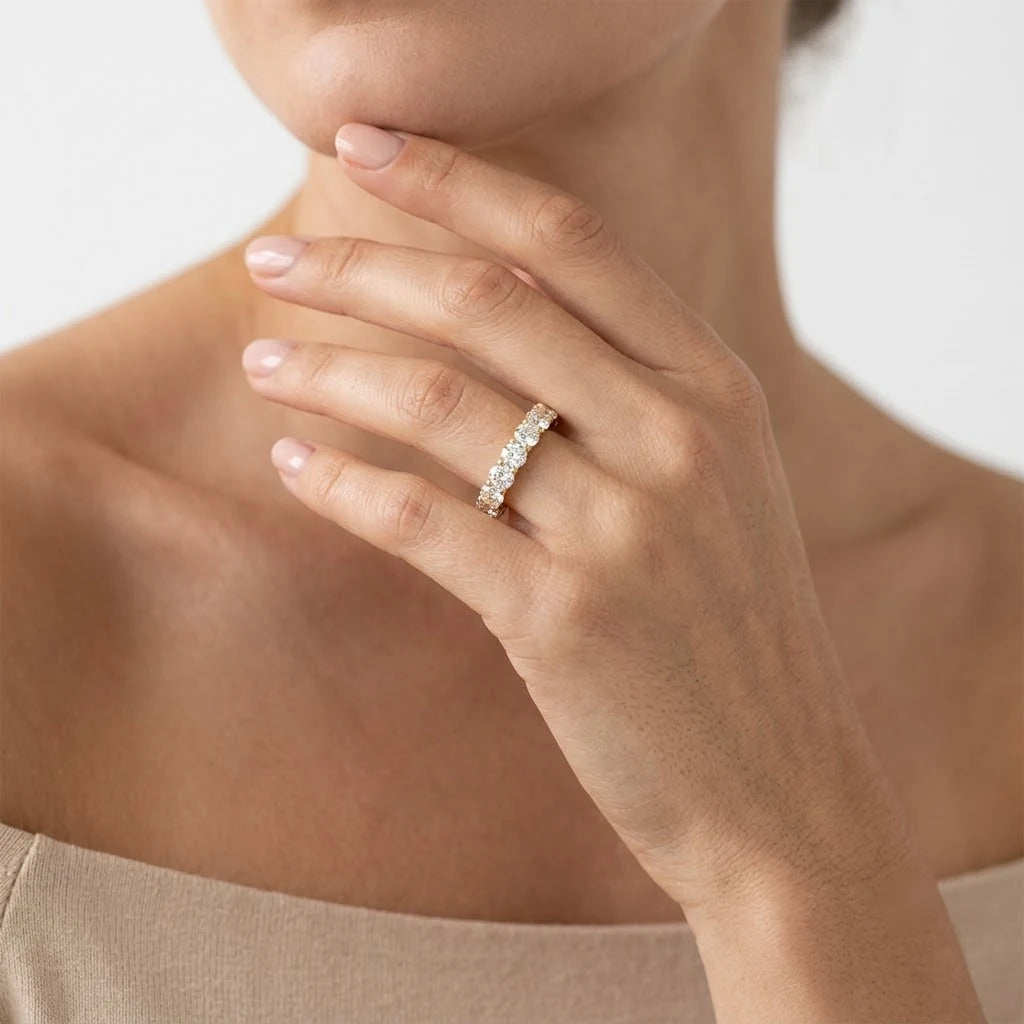 FineDiam yellow gold diamond band ring featuring closely set round diamonds in a detailed setting.