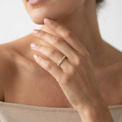 FineDiam yellow gold half eternity ring showcasing individually set round diamonds in a close-up view.
