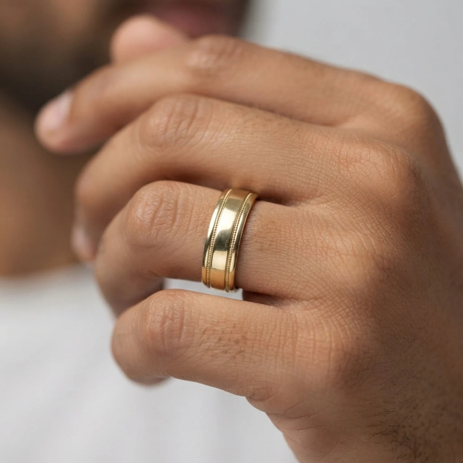 FineDiam polished yellow gold wedding ring featuring a broad centre band with fine beaded milgrain borders.