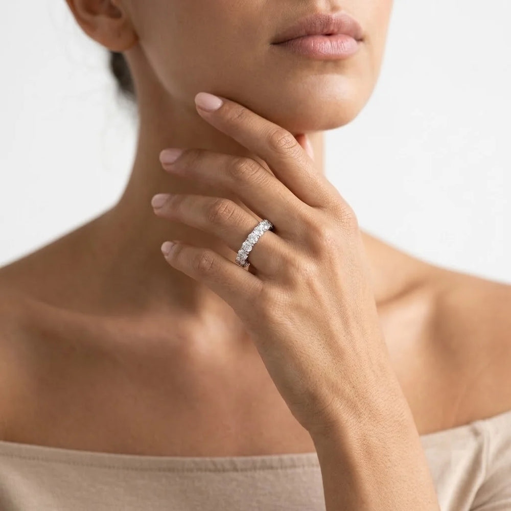 FineDiam white metal diamond eternity ring featuring closely set round stones along the band.