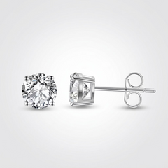 Gold stud earrings featuring round solitaire diamonds for her.