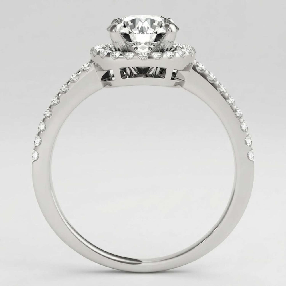 Angled perspective view of a handcrafted round diamond engagement ring in polished white gold.