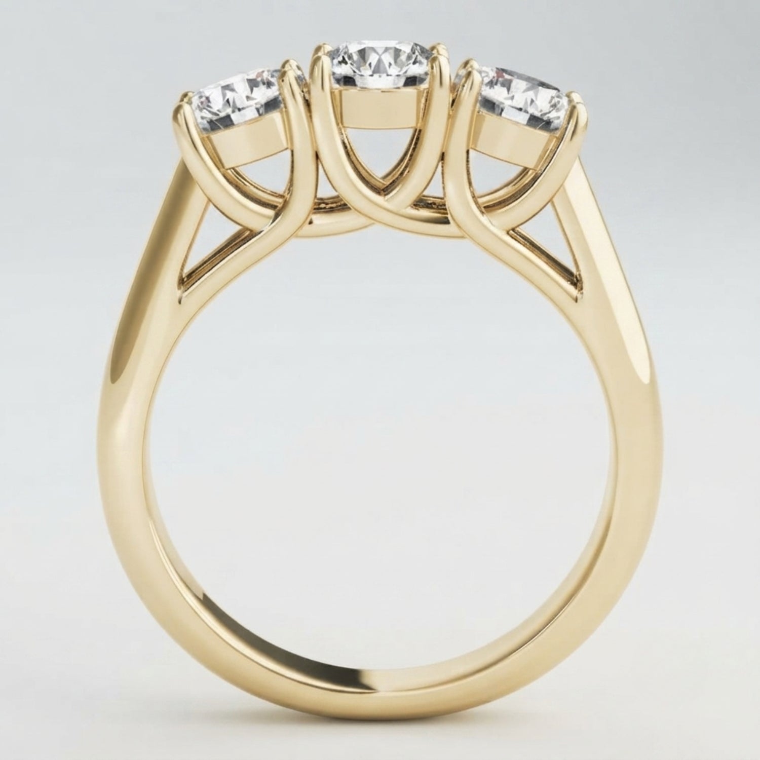 Angled perspective view of a handcrafted three-stone diamond engagement ring in polished white gold.