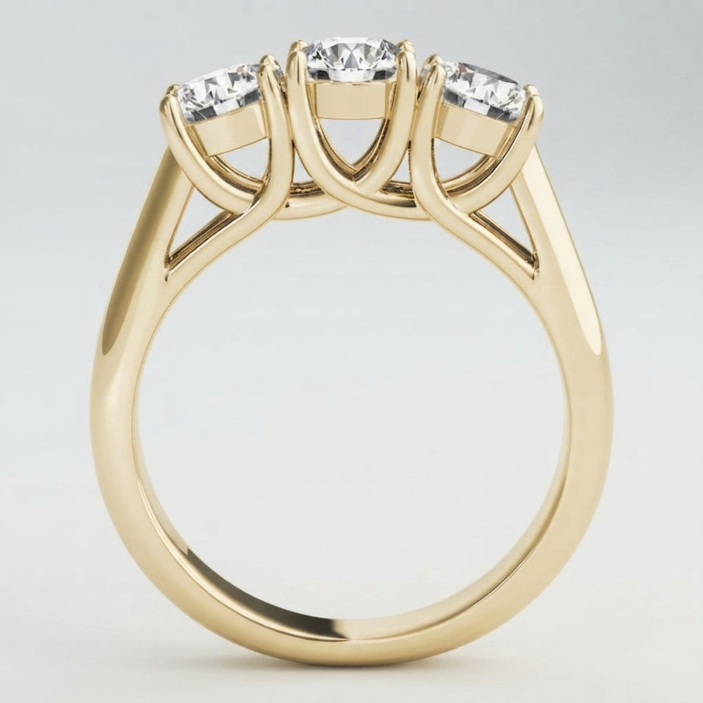 Angled perspective view of a handcrafted three-stone diamond engagement ring in polished white gold.