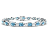 Bezel Set Oval Cut Blue Topaz and Round Diamond Tennis Bracelet in 9K White Gold