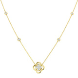 Gold necklace with a clover-shaped pendant on a white background