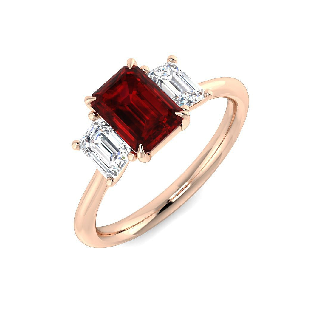 Ruby Three Stone Ring with emerald cut ruby and diamond side stones in prong setting.