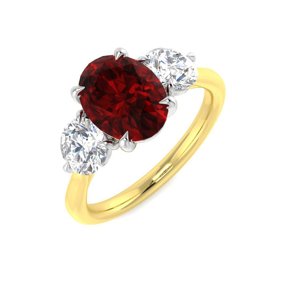Ruby Three Stone Ring with oval cut ruby and diamond side stones on a gold band.