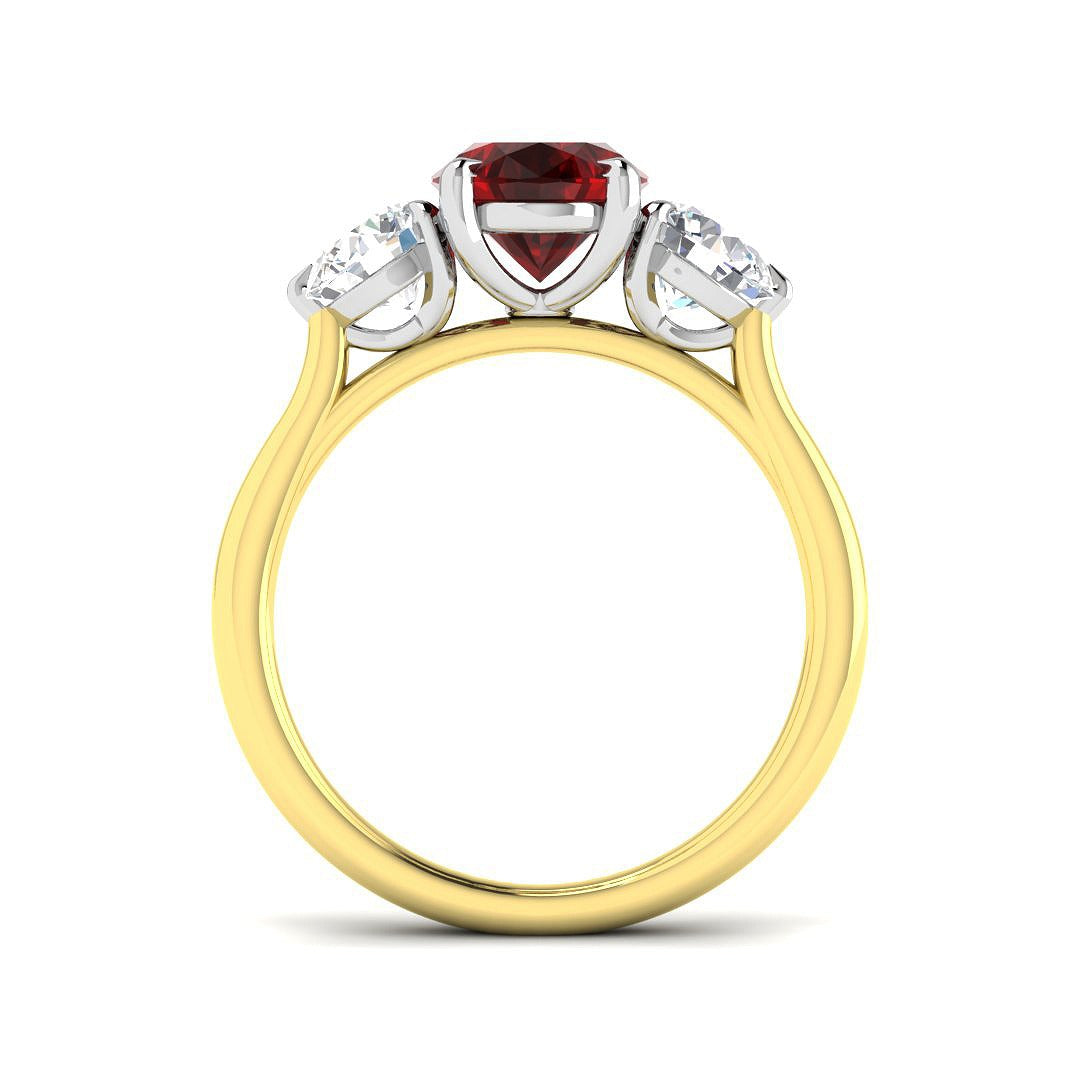 Ruby Three Stone Ring showcasing an oval cut ruby center and diamond side stones, set in gold.