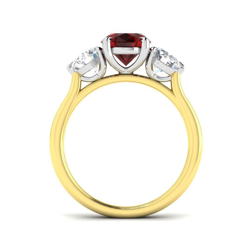 Ruby Three Stone Ring showcasing an oval cut ruby center and diamond side stones, set in gold.