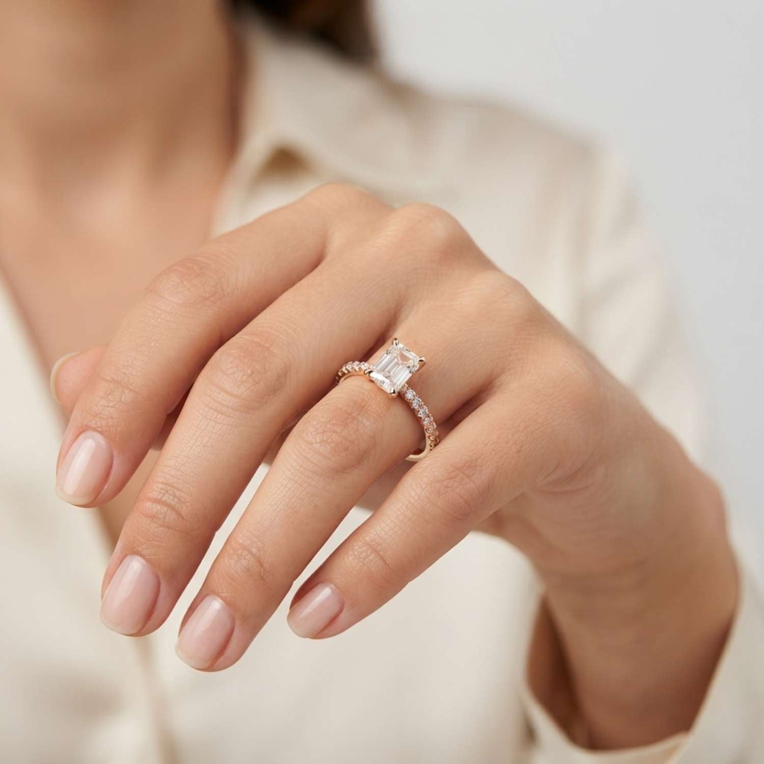 Modern 18K white gold engagement ring centered with a sophisticated emerald-cut lab-grown diamond.