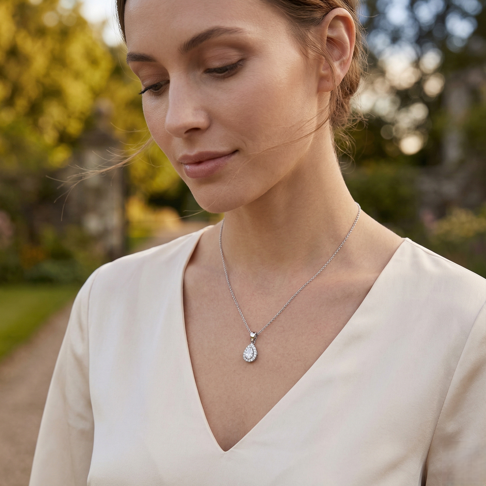 Woman wearing a necklace with a pendant outdoors