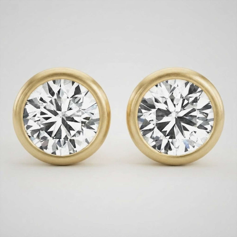 Elegant platinum round brilliant diamond stud earrings featuring a secure full bezel frame.
