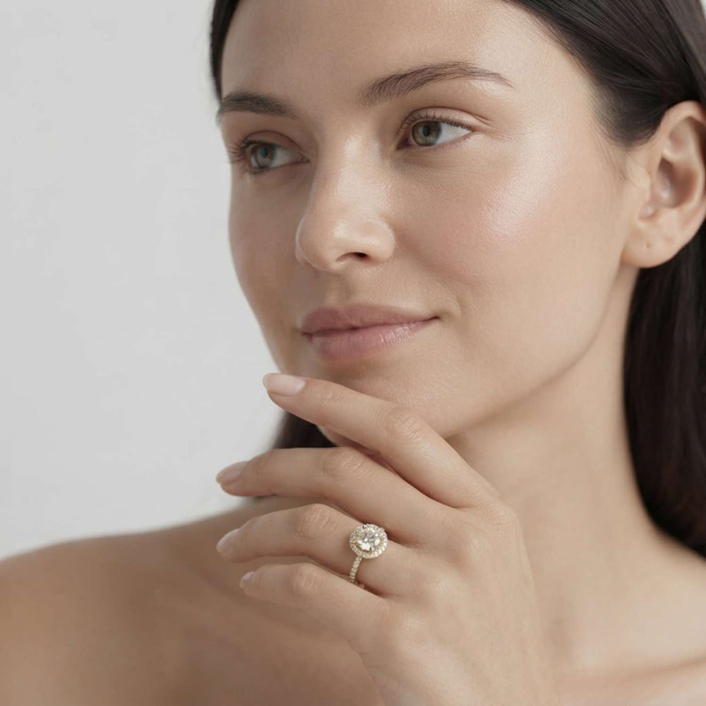 Side profile view of a prong-set centre and pavé-set side diamond ring showing basket construction.