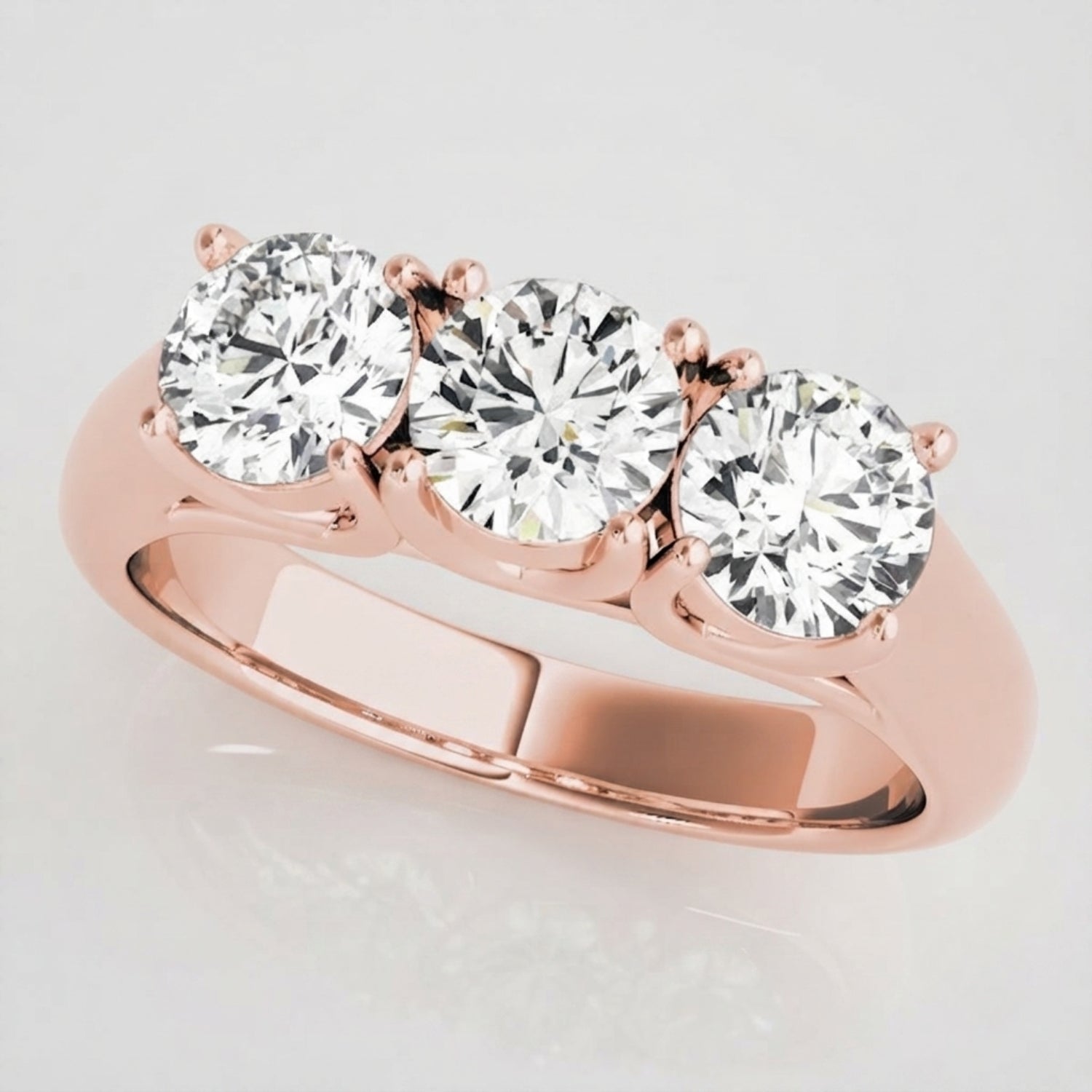 Side profile view of a classic prong-set three-stone round diamond ring showing basket construction.