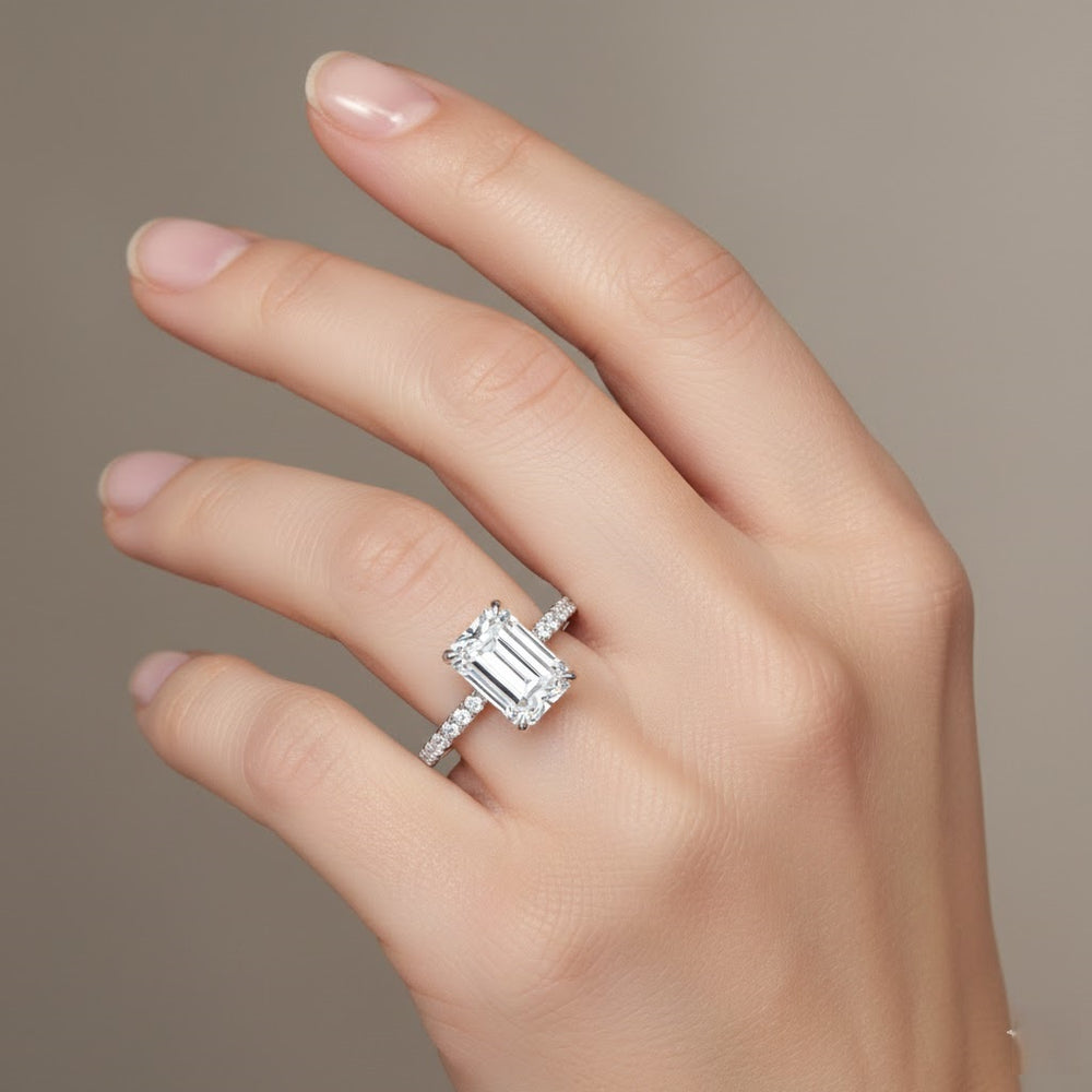 Diamond ring on a hand against a neutral background