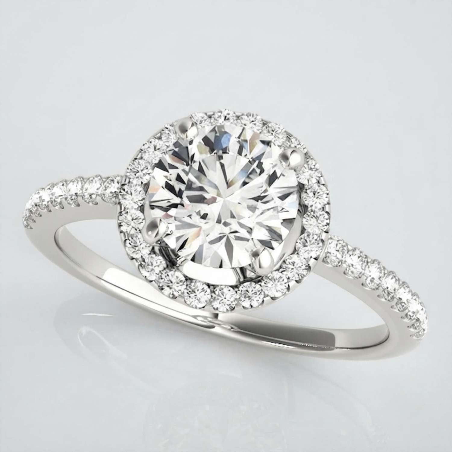 Top-down view of a round cut lab-grown diamond engagement ring featuring a brilliant centre stone and pavé-set shoulders in yellow gold.