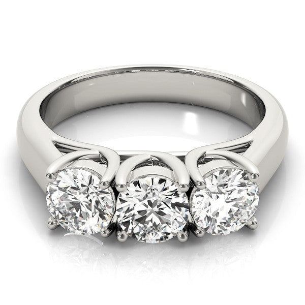 Top-down view of a classic three-stone lab-grown diamond engagement ring featuring three round brilliant diamonds in yellow gold.