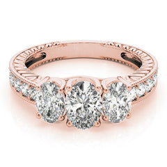 Rose gold ring with three diamonds on a white background