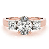 Rose gold ring with three diamonds on a white background