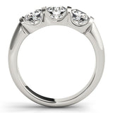 Silver ring with three heart-shaped diamonds on a white background