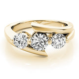 Gold ring with three diamonds on a white background