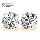 Pair of diamond earrings with International Gemological Institute logo.