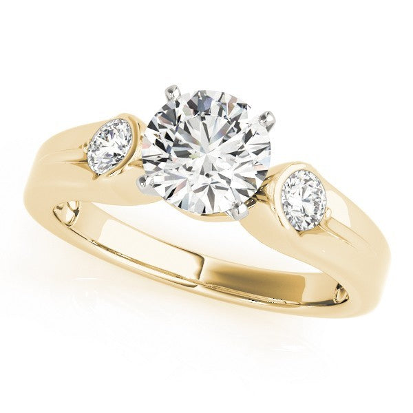 Gold ring with a large central diamond and two smaller diamonds on a white background