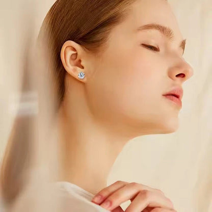 Close-up of a woman wearing a diamond earring with a soft background