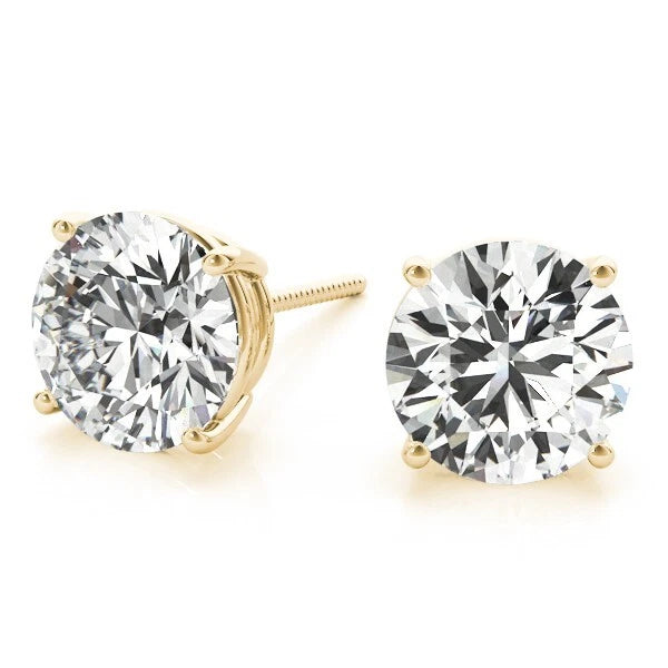 Gold stud earrings with large clear gemstones on a white background