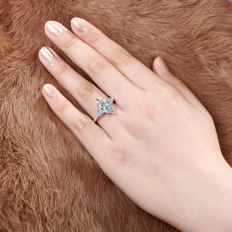 Hand wearing a diamond ring on a brown fur background
