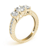 Gold ring with three clear gemstones on a white background