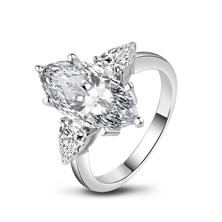 Silver ring with three pear-shaped diamonds on a white background