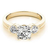 Gold ring with a central diamond flanked by two smaller diamonds on a white background