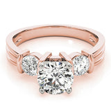 Rose gold ring with three diamonds on a white background
