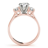 Rose gold ring with a central diamond and two smaller diamonds on a white background