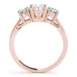 Rose gold ring with three diamonds on a white background