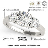 Three-stone diamond engagement ring with hallmarking details on a white background