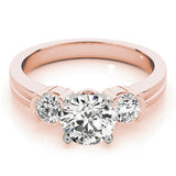 Rose gold ring with three diamond stones on a white background