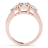 Rose gold ring with three diamonds on a white background